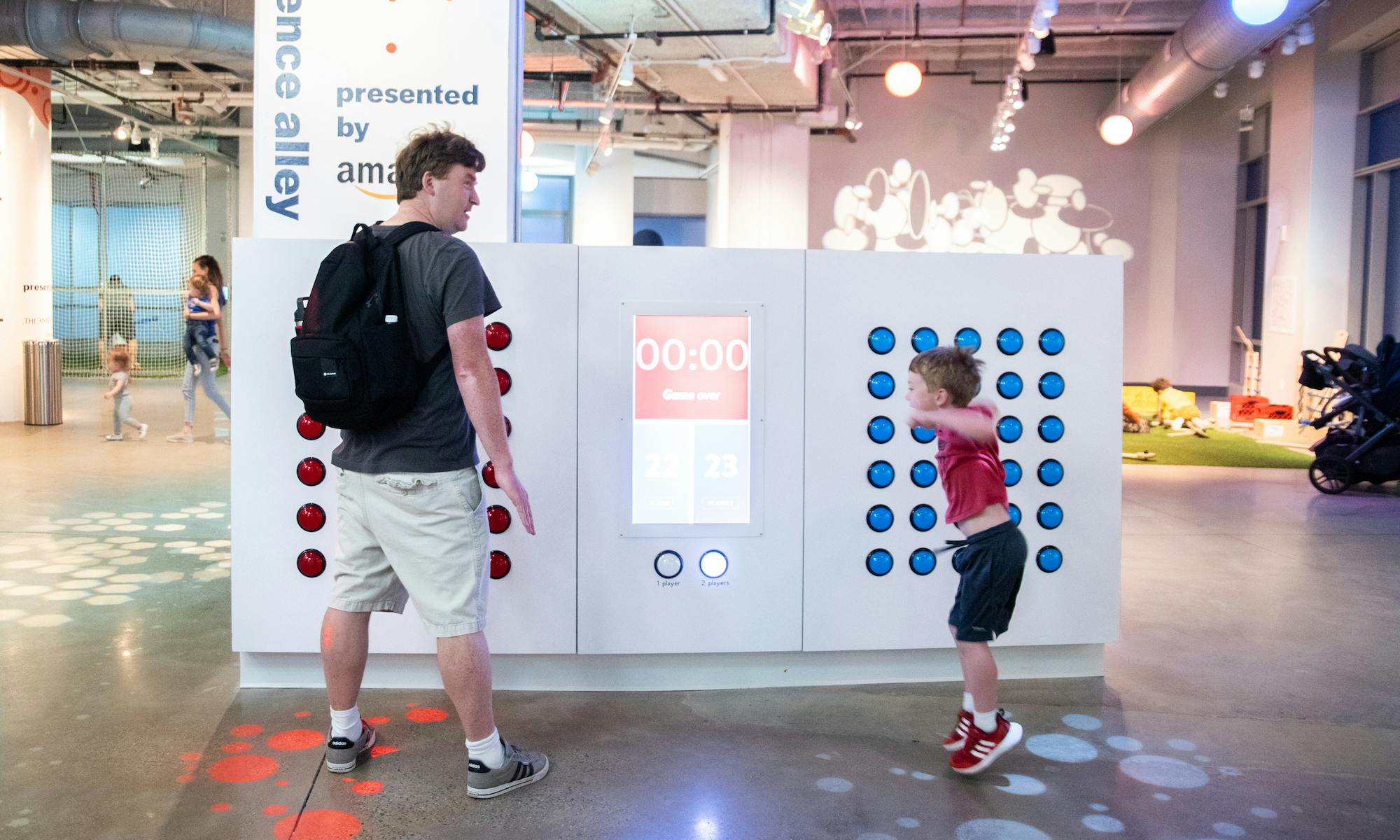 Father and son at the React experience in the Data Science Alley exhibit