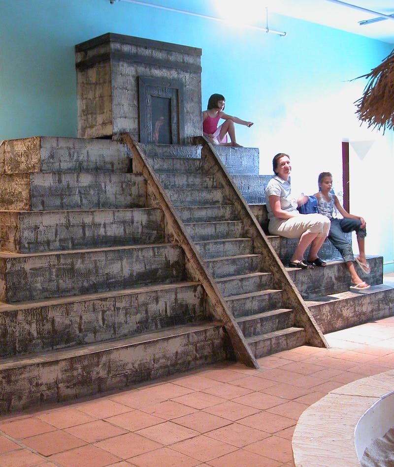 Visitors sitting on a structure modeled after Mexican ruins in the Mexico Exhibit from Capital Children's Museum