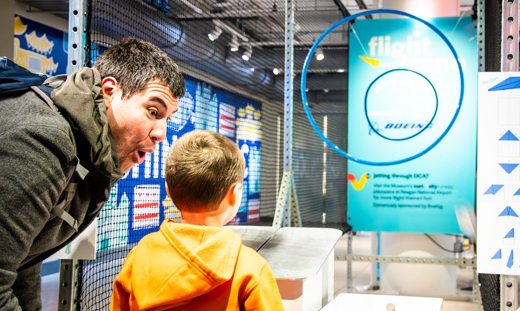 Adult and child at the Flight Zone experience in the Engineering Games + Play exhibit