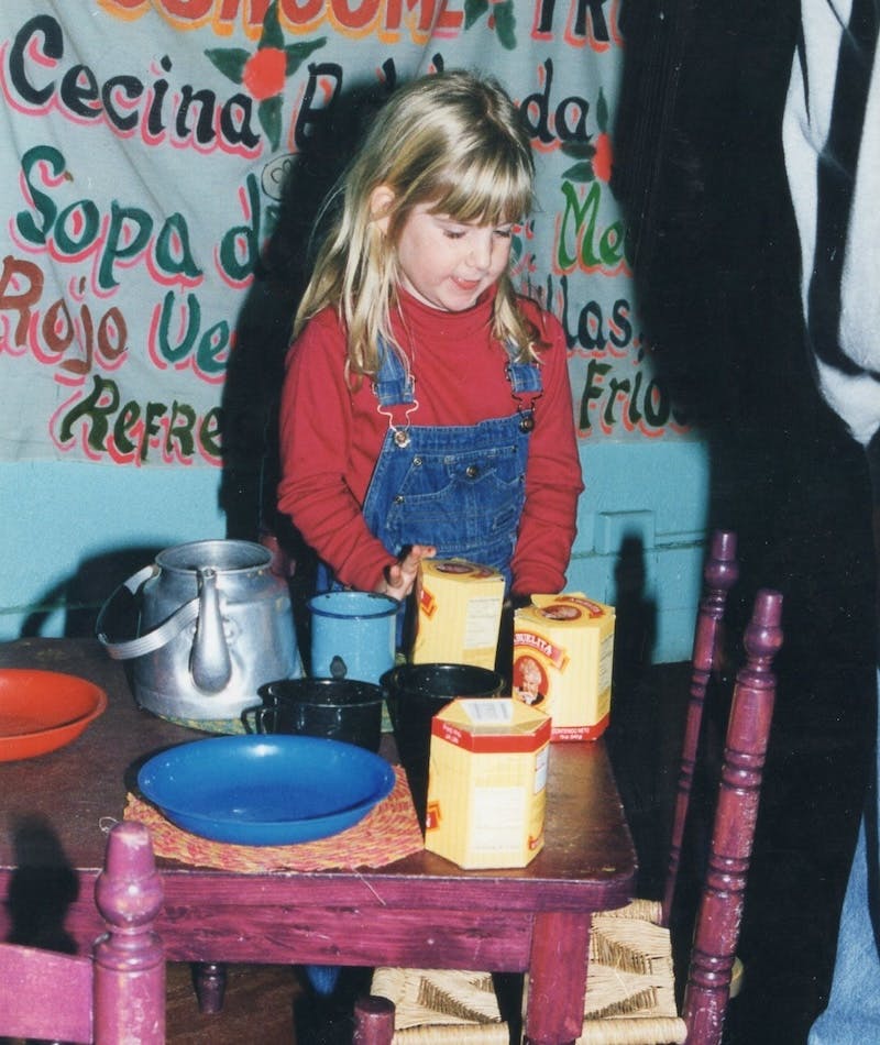 Young girl making Mexican hot chocolate in the Mexico Exhibit from Capital Children's Museum