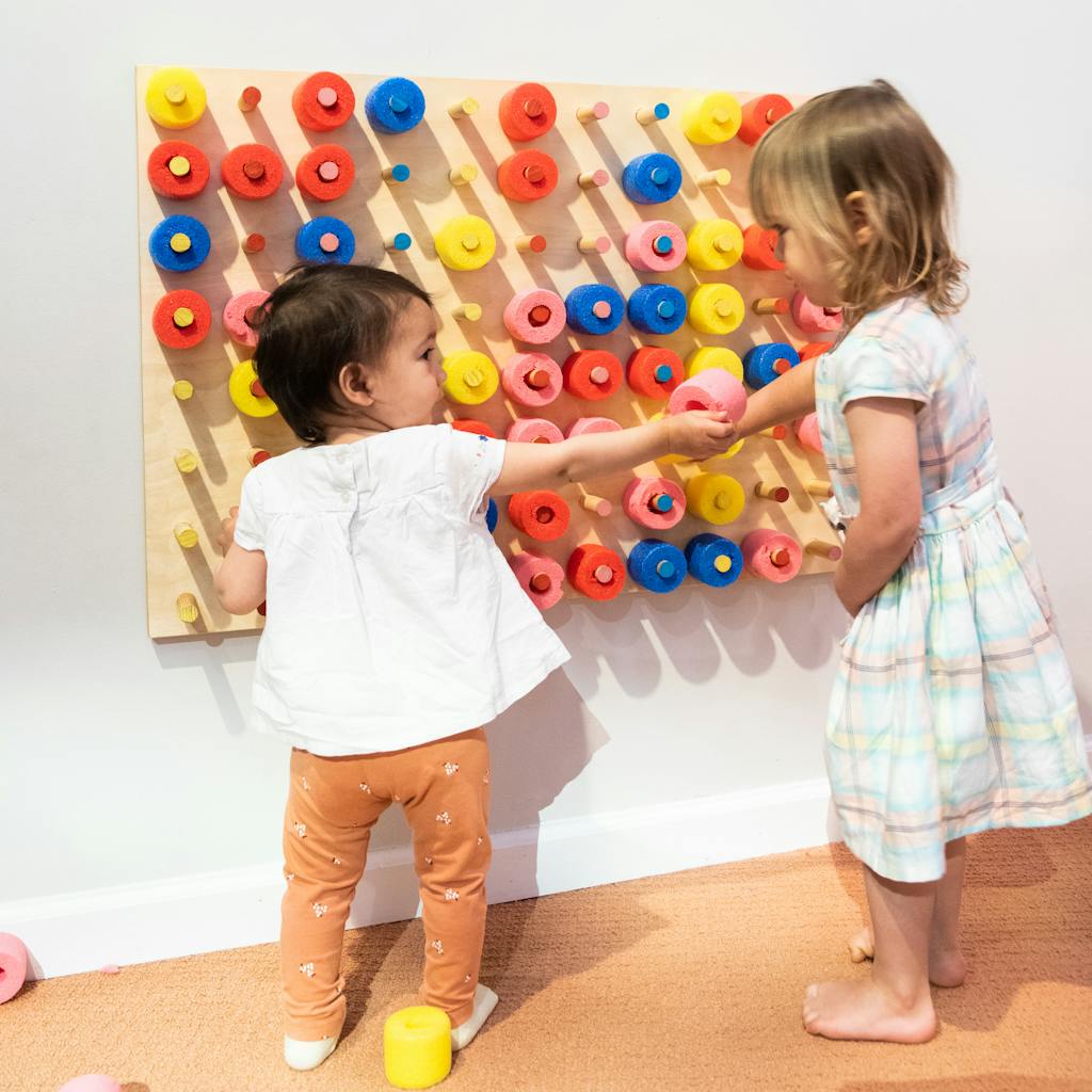 Toddlers at the peg wall in the Little Dreamers exhibit