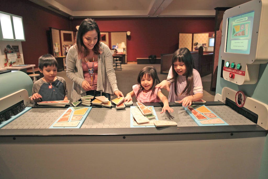 Family in the Mindbender Mansion exhibit