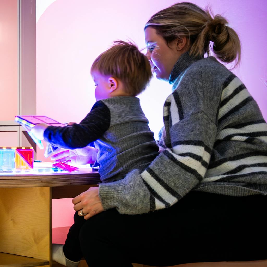 Adult and child playing at light table.