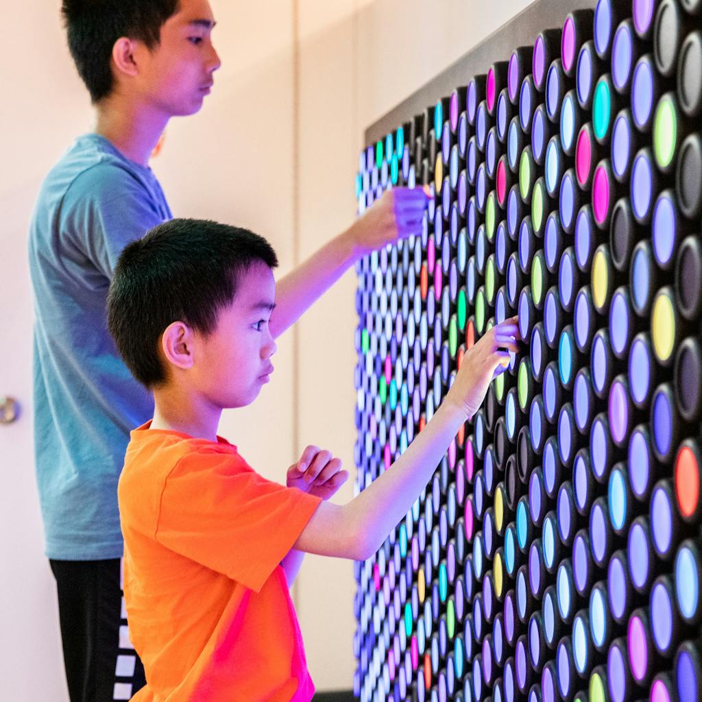 Two boys at Everbrite in the Data Science Alley exhibit