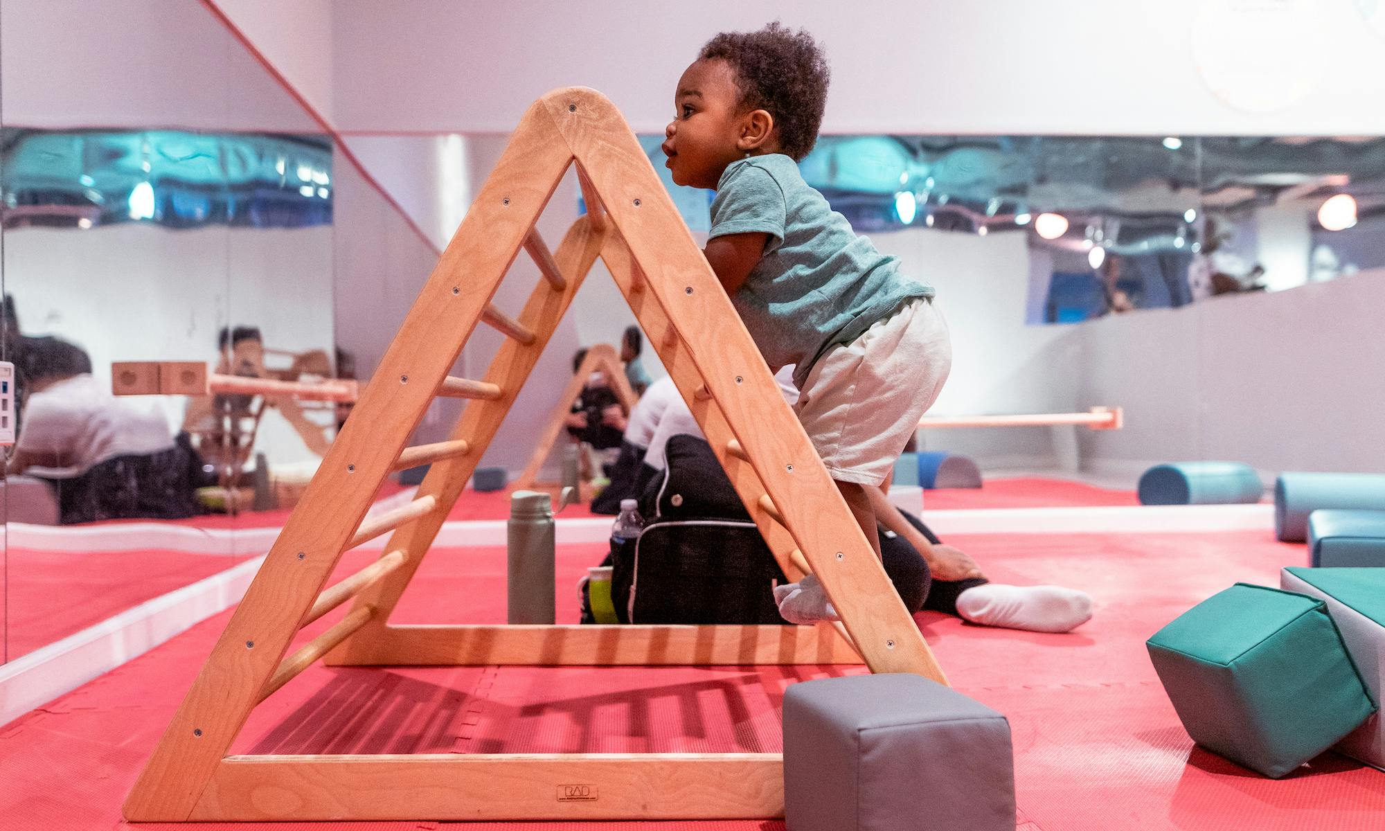 Toddler climbing in the Little Movers exhibit