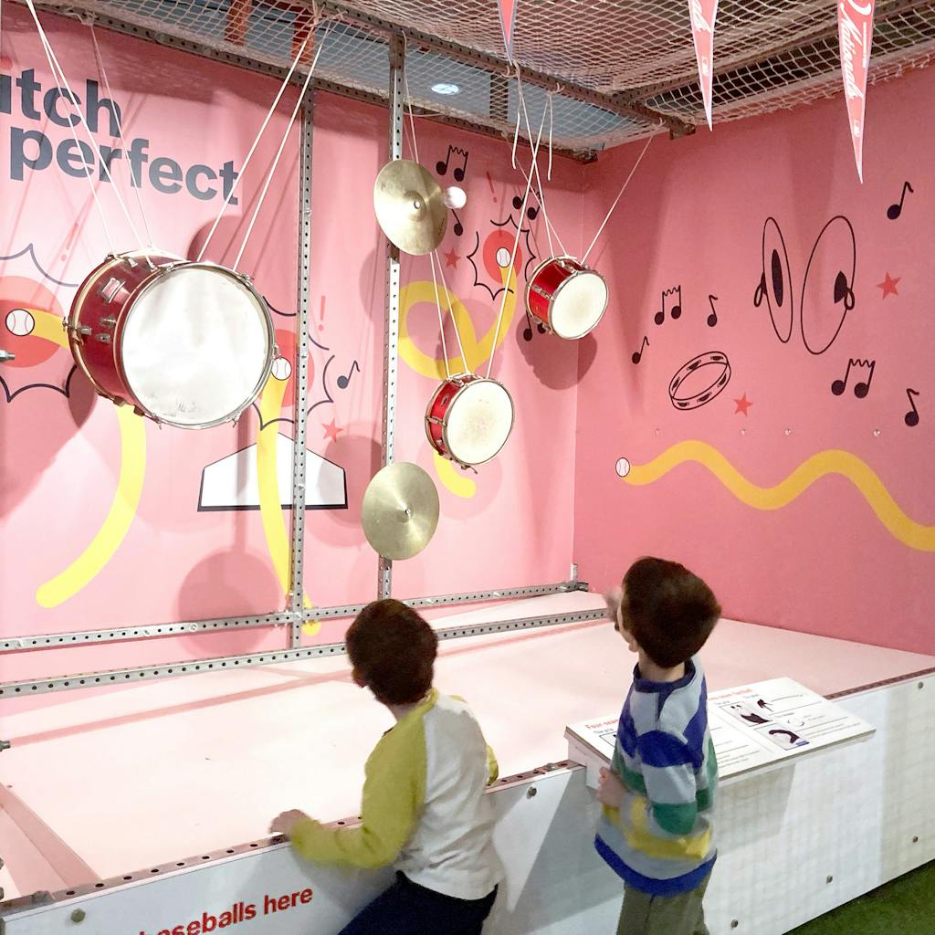 Two young boys at the Pitch Perfect experience in the Engineering Games + Play exhibit