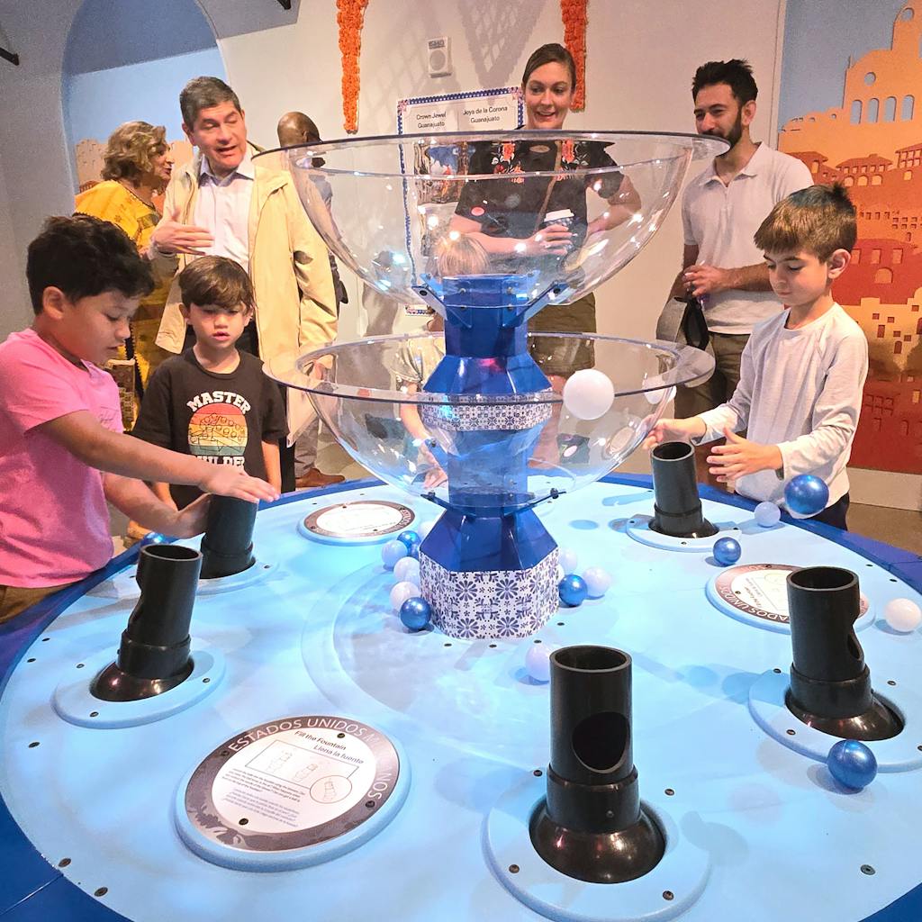 Group of young boys at the Bernoulli Fountain in the Placita Magica exhibit